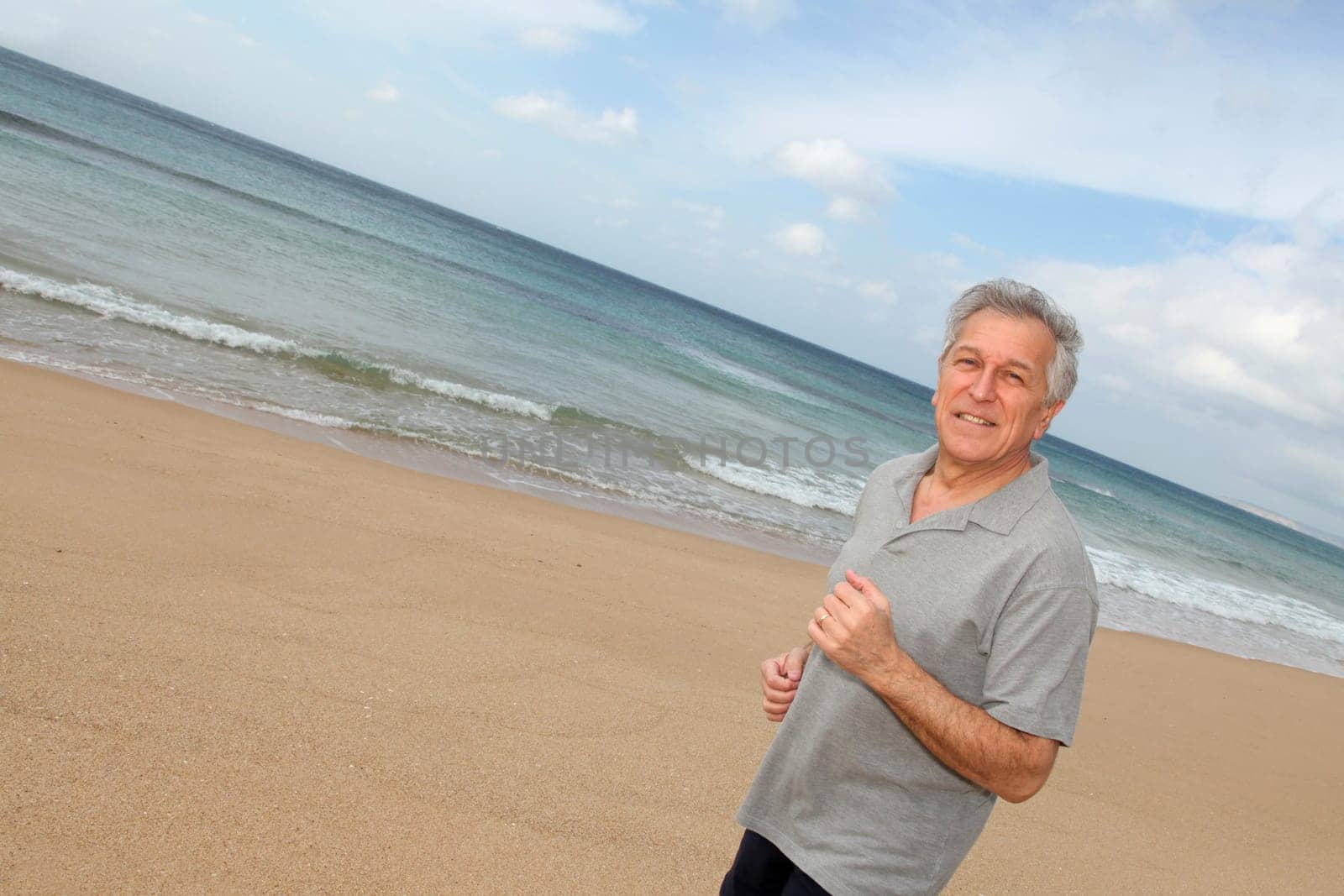 Senior man running on the beach