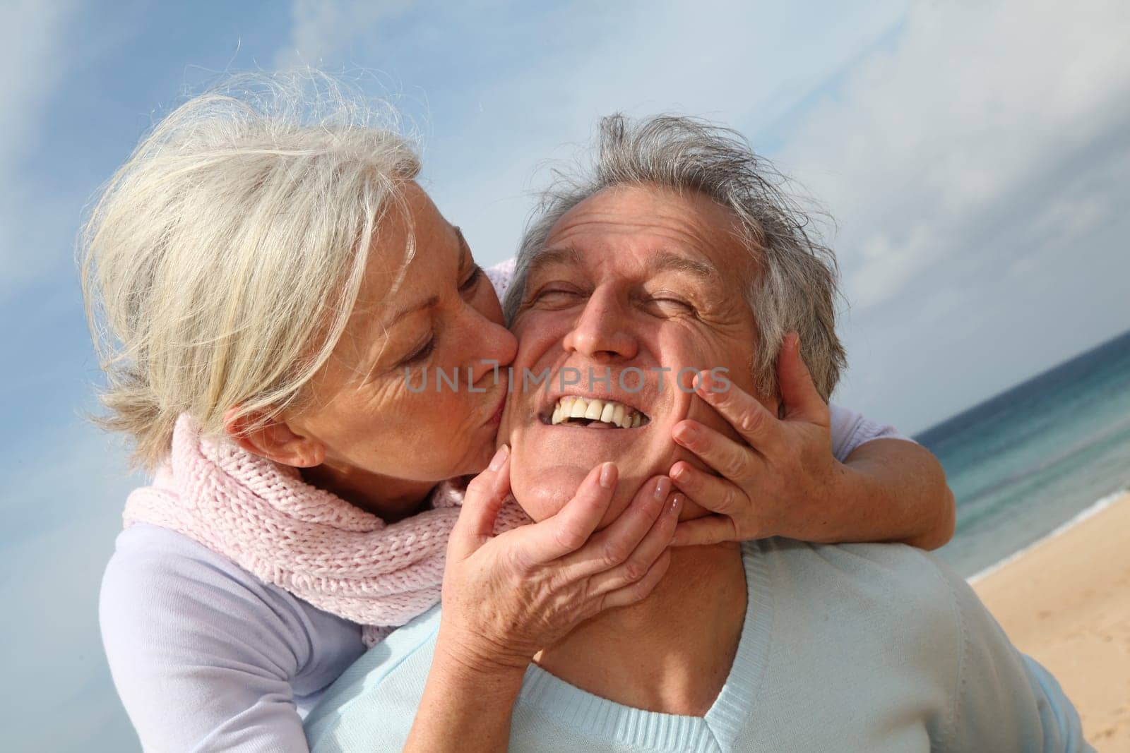 Happy senior couple at the beach