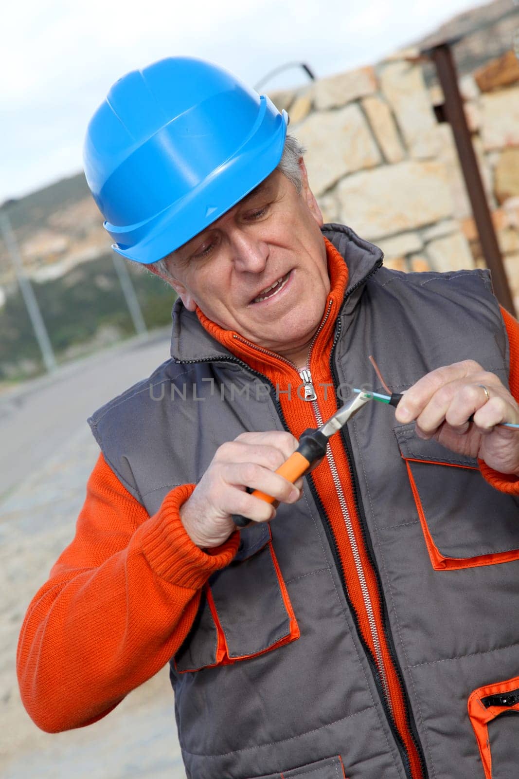 Worker with security helmet installing gate system
