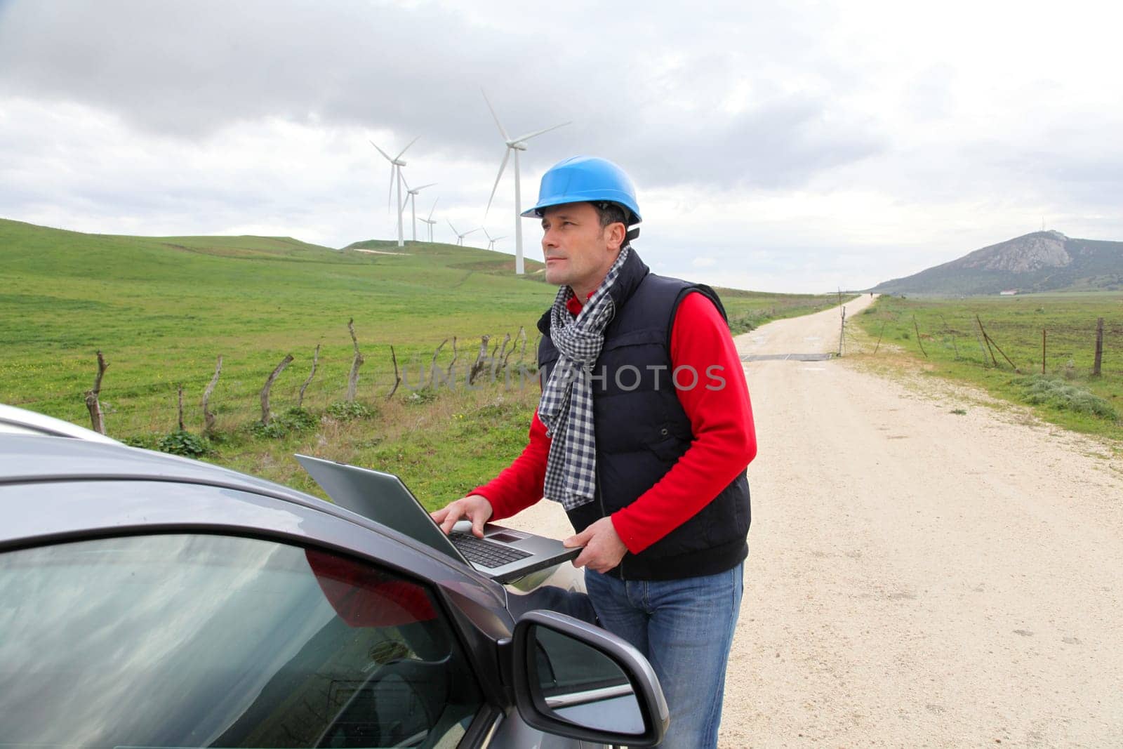 Engineer working on laptop computer in wind turbines field