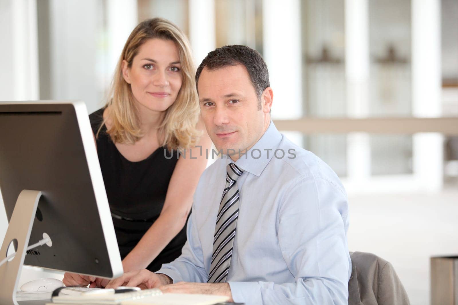 Office workers in front of computer