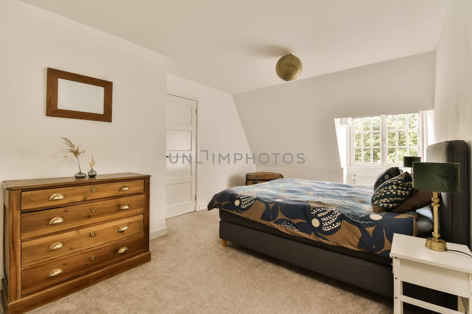 a bedroom with a bed, dresser and mirror on the wall in front of the room is very white color