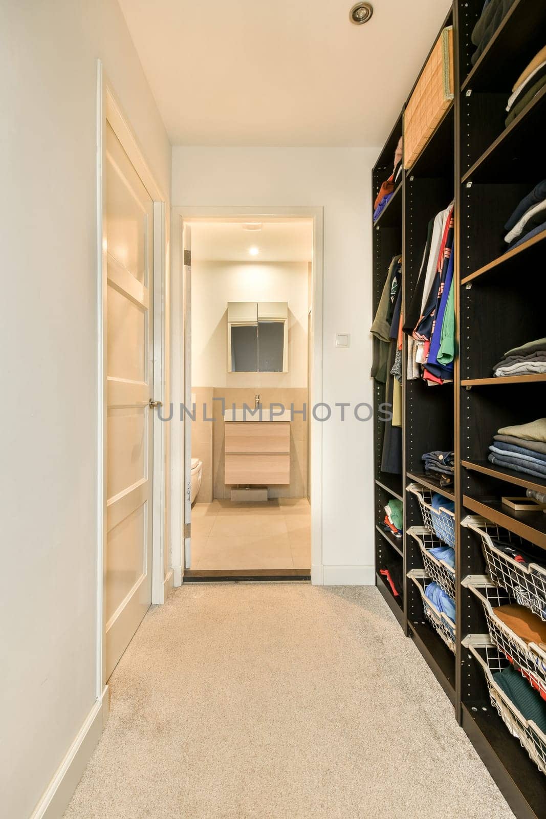 a closet with shelves and a sink in a bathroom by casamedia