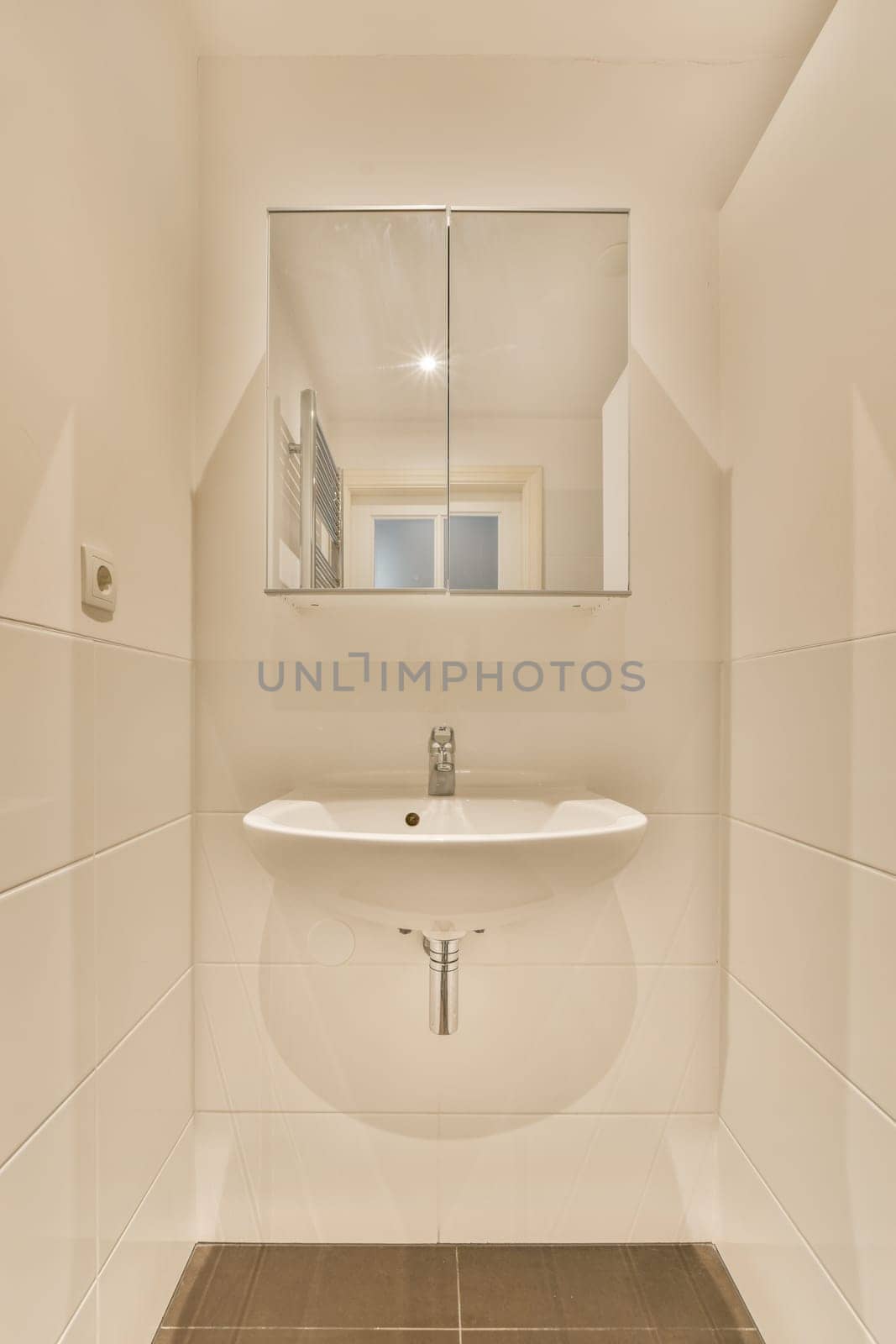 a white bathroom with a sink and a mirror by casamedia