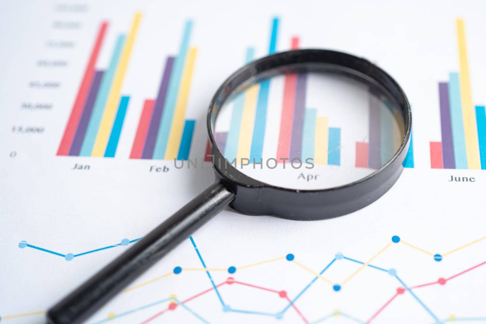 Magnifying glass on charts graphs paper. Financial development, Banking Account, Statistics, Investment Analytic research data economy. by pamai