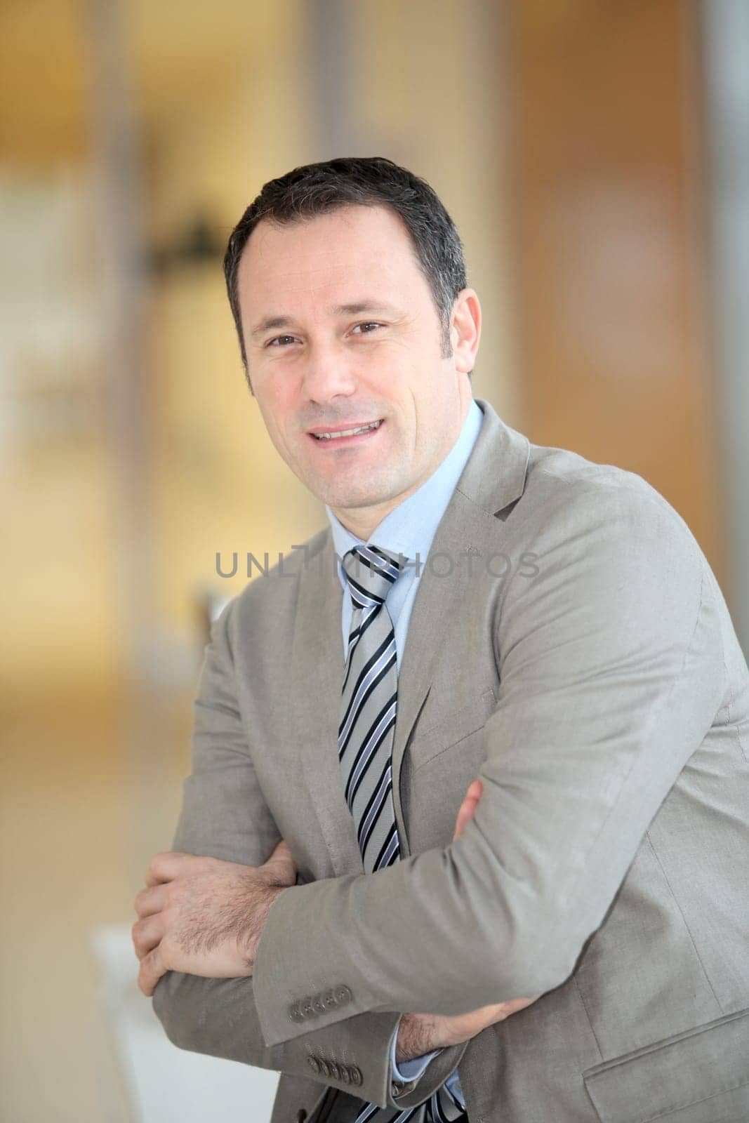 Portrait of smiling businessman with grey suit