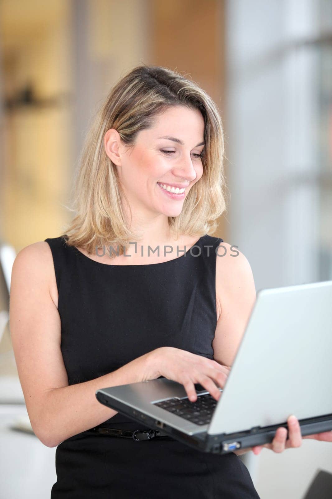 Smiling businesswoman usin laptop computer