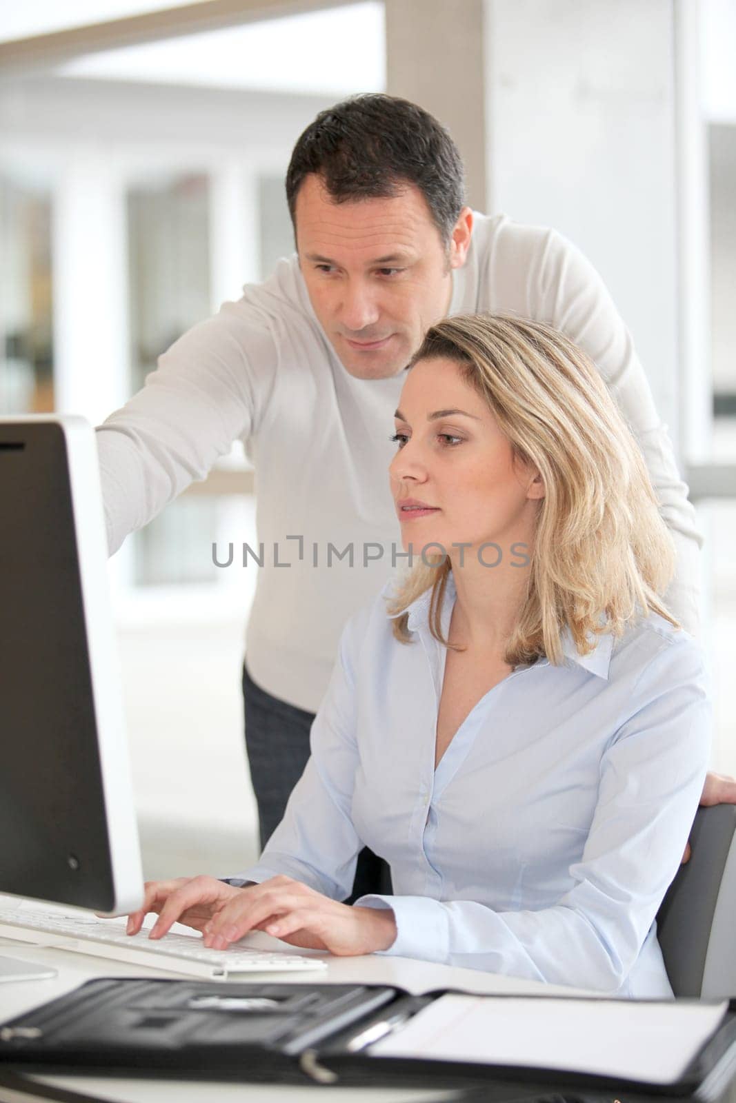 Office workers in front of desktop computer