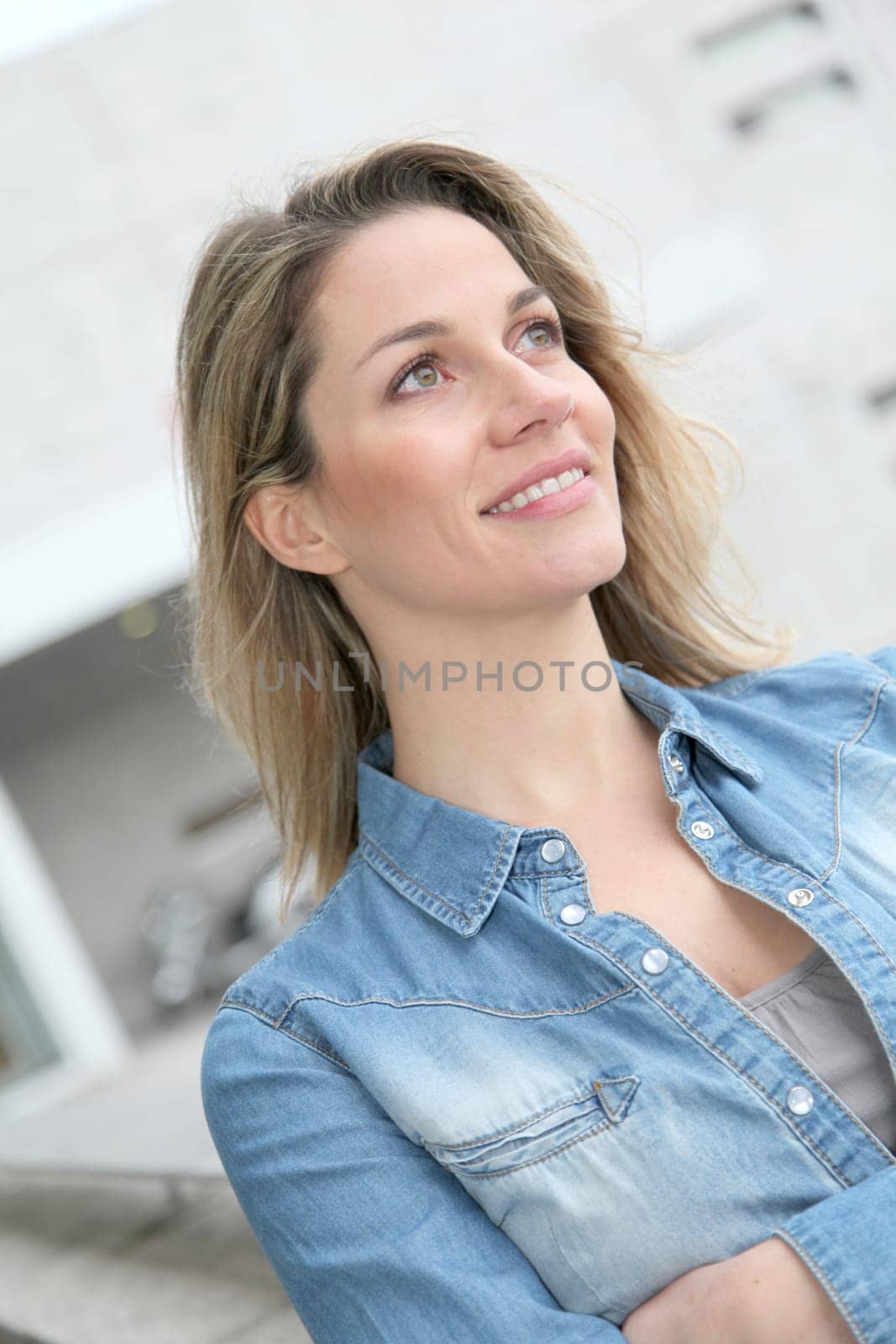 Portrait of beautiful blond woman in town