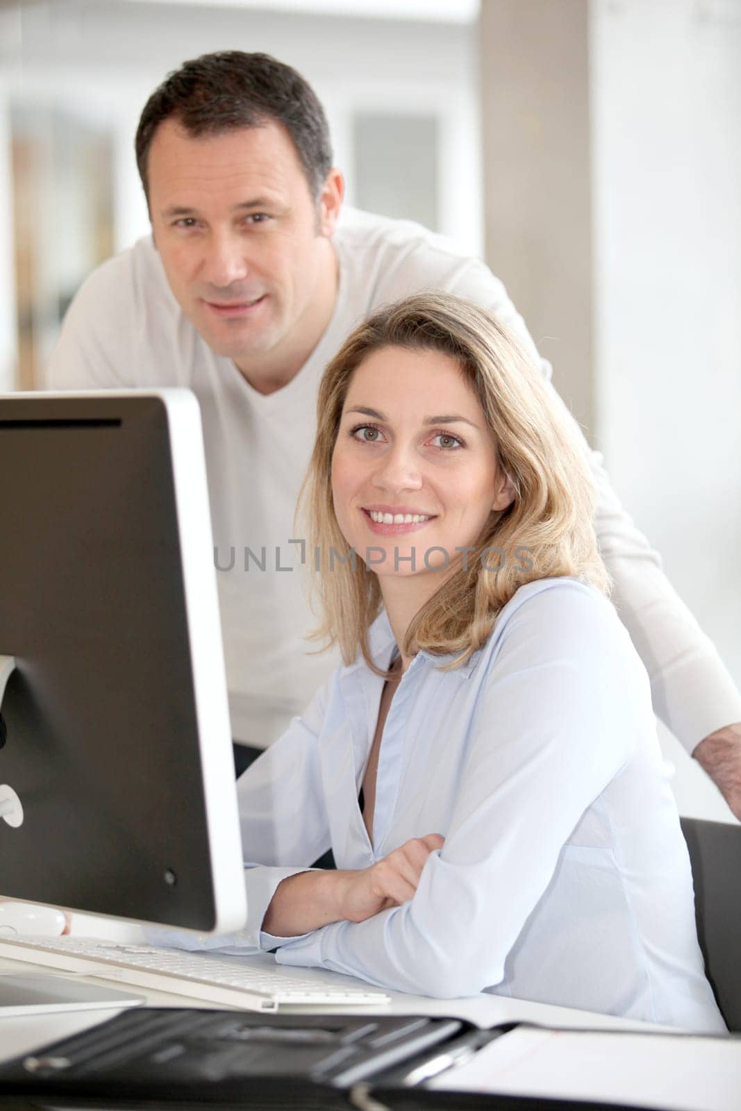 Office workers in front of desktop computer