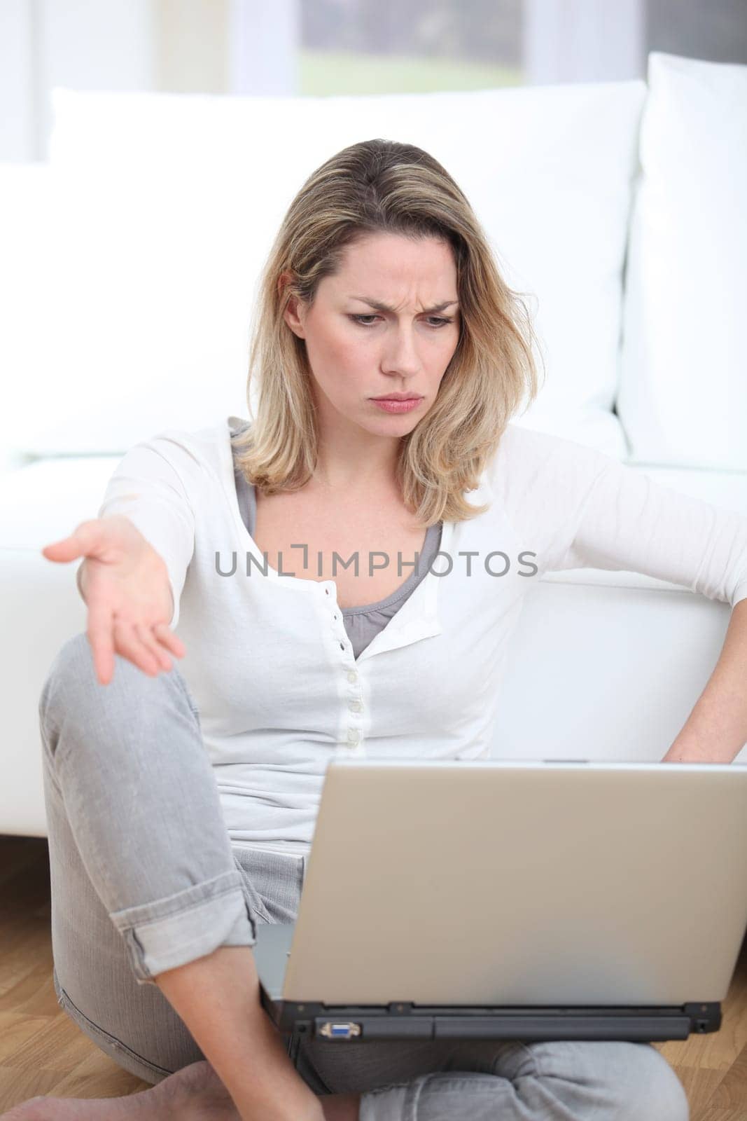 Woman with thoughtful look using laptop computer