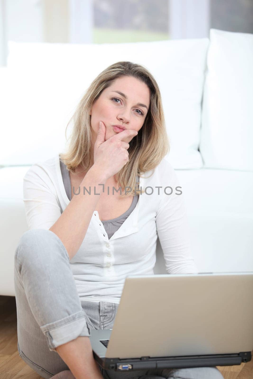 Woman with thoughtful look using laptop computer