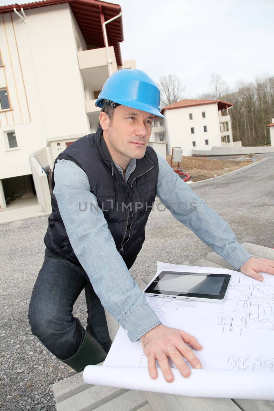 Engineer on construction site with electronic tab