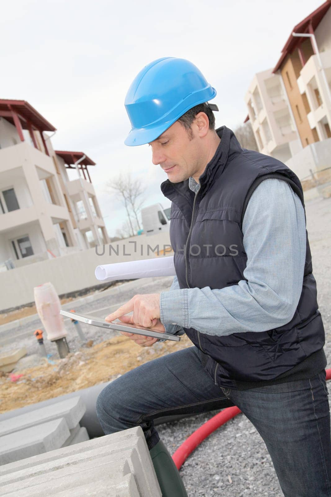Supervisor using electronic tab on construction site