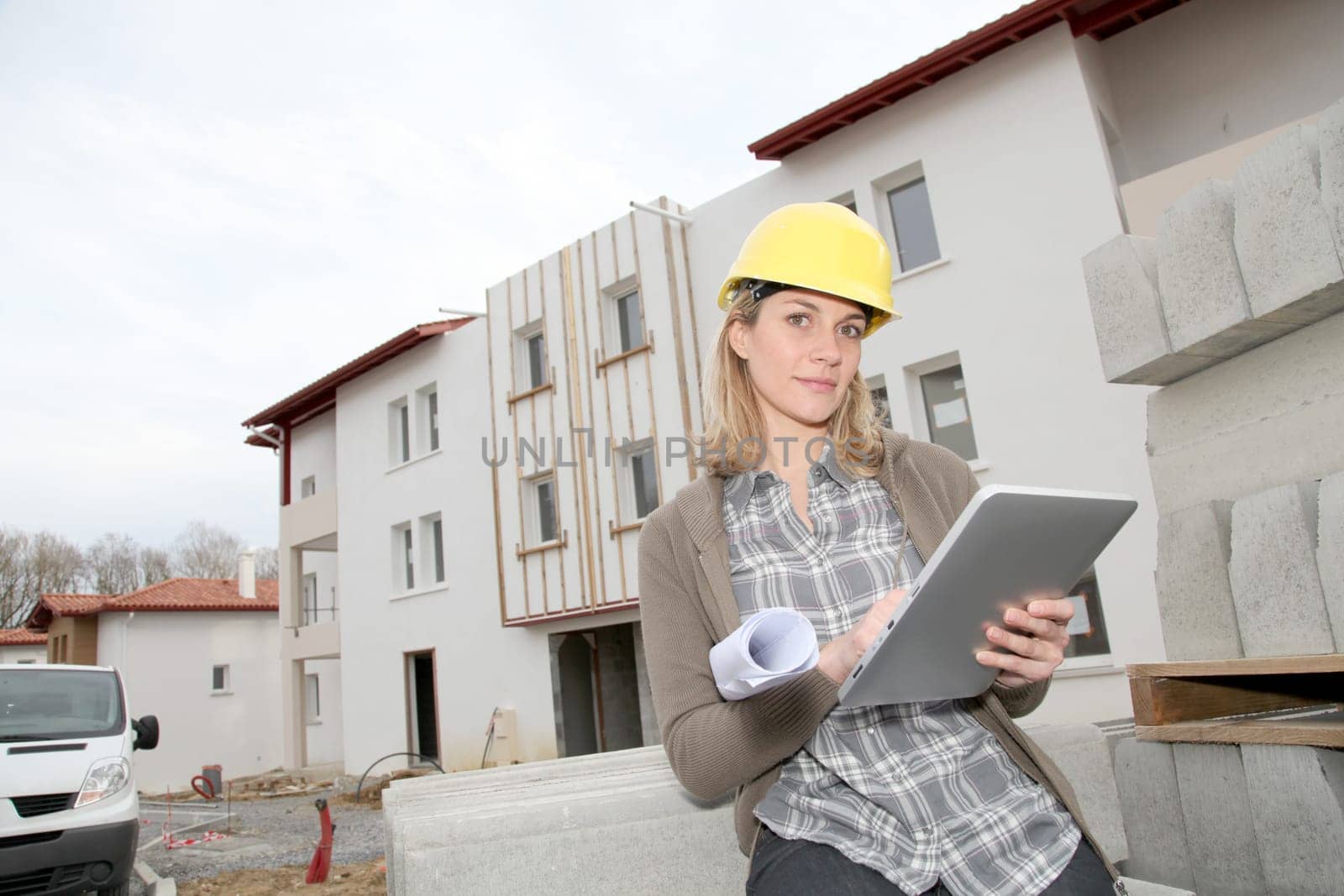 Woman engineer with security helmet standing on construction site