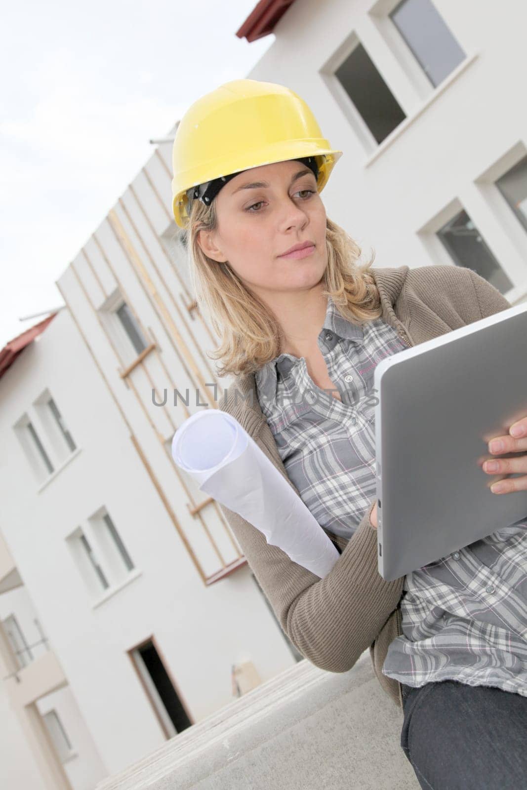Woman engineer with security helmet standing on construction site