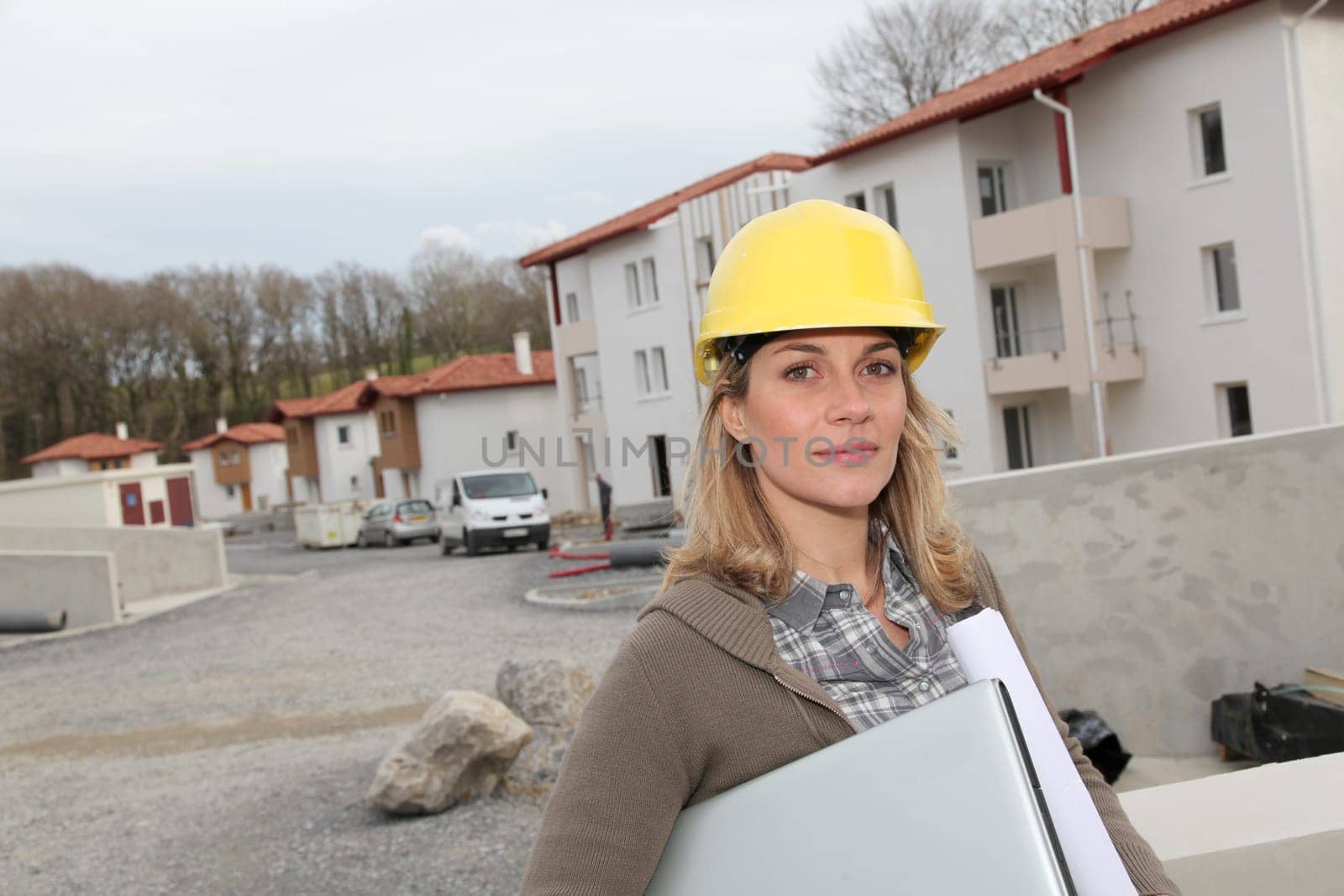 Woman engineer with security helmet standing on construction site