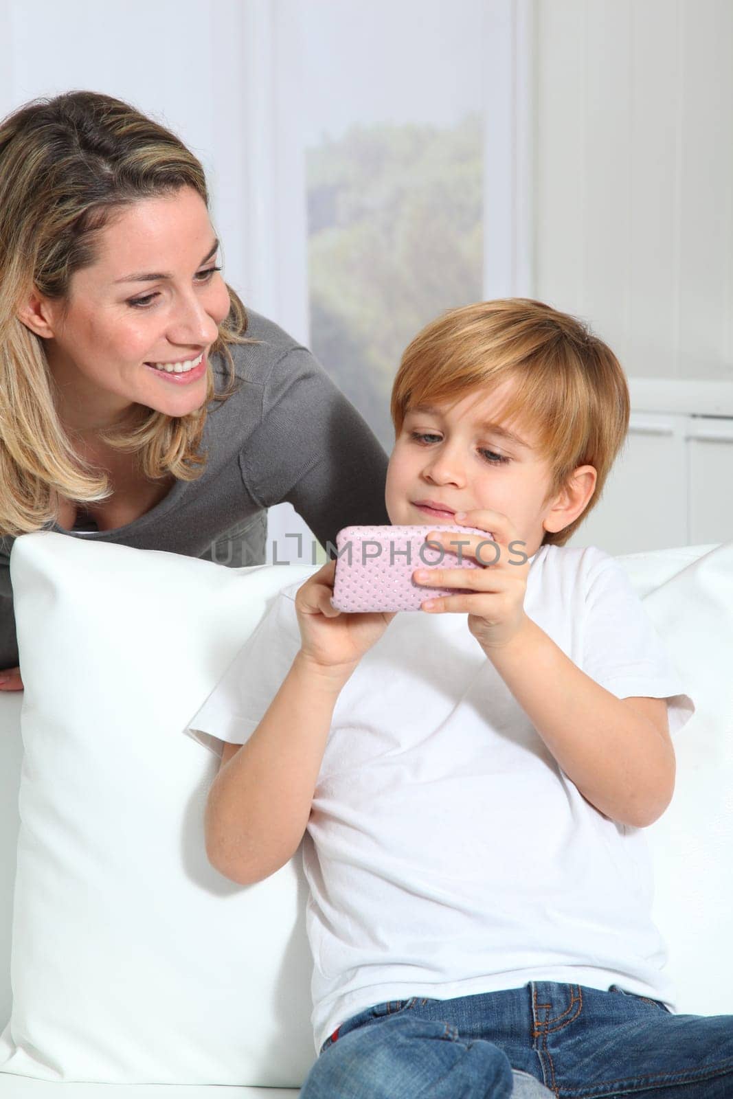 Mother and son playing video game on telephone