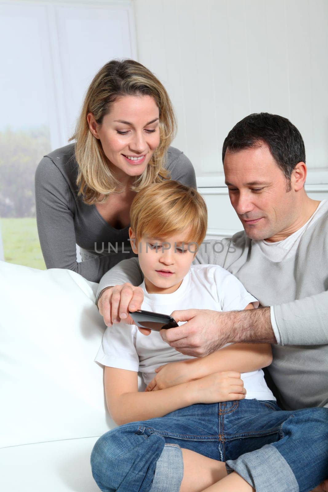 Family playing video game on smartphone