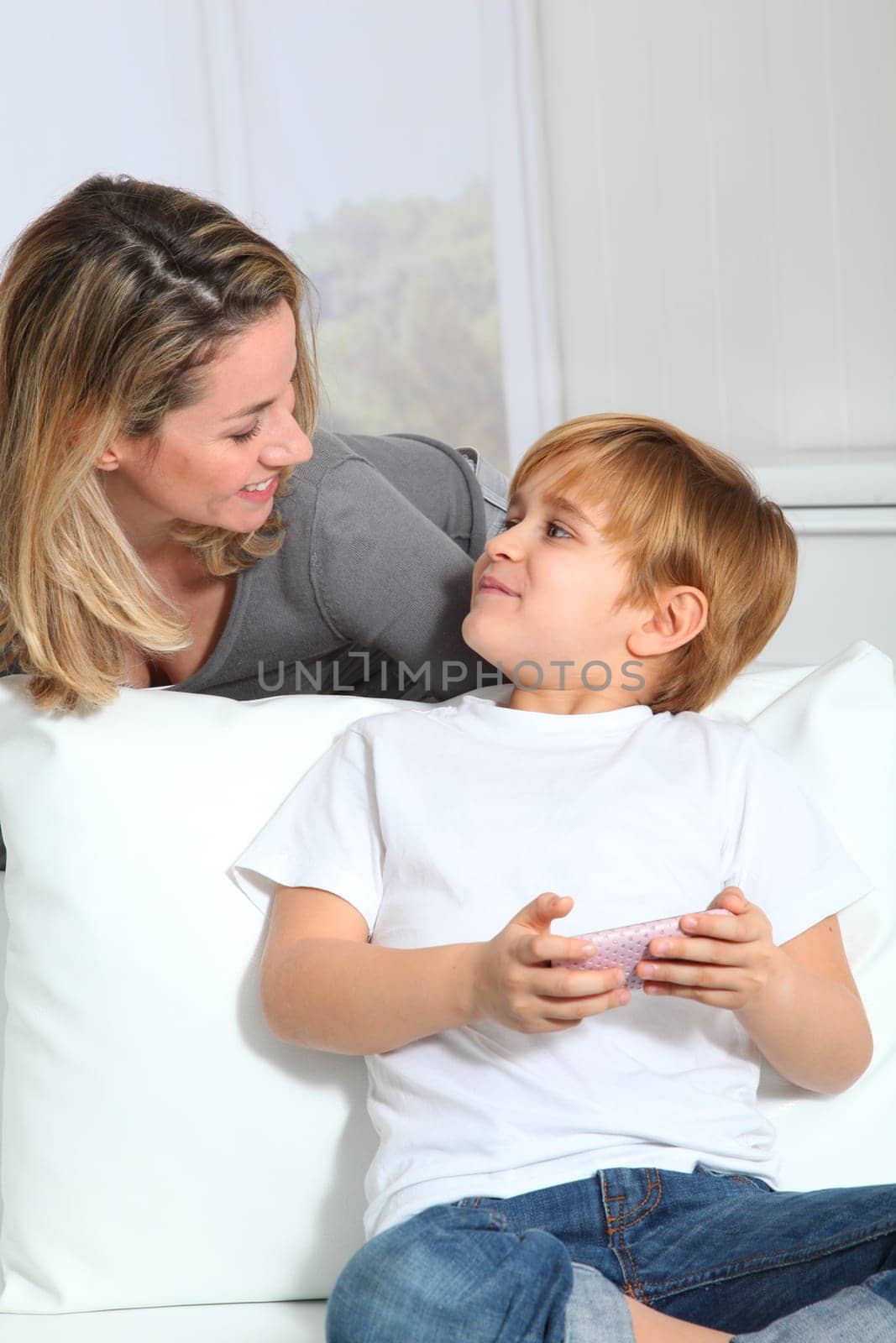 Mother and son playing video game on telephone