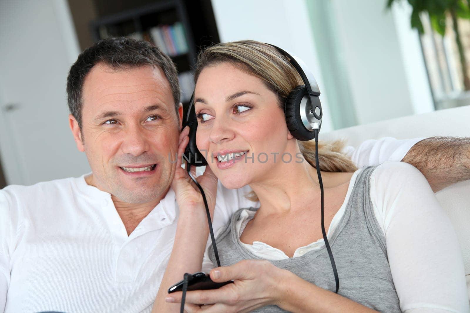Couple listening to music with headphones