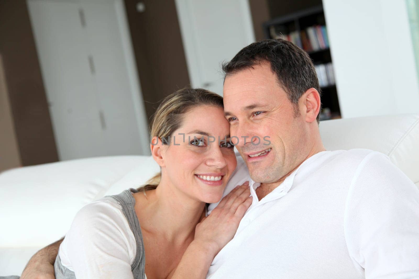 Portrait of couple relaxing at home in sofa