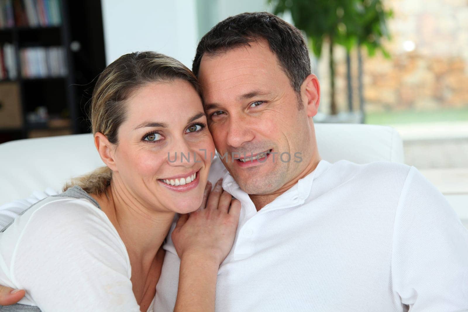 Portrait of couple relaxing at home in sofa