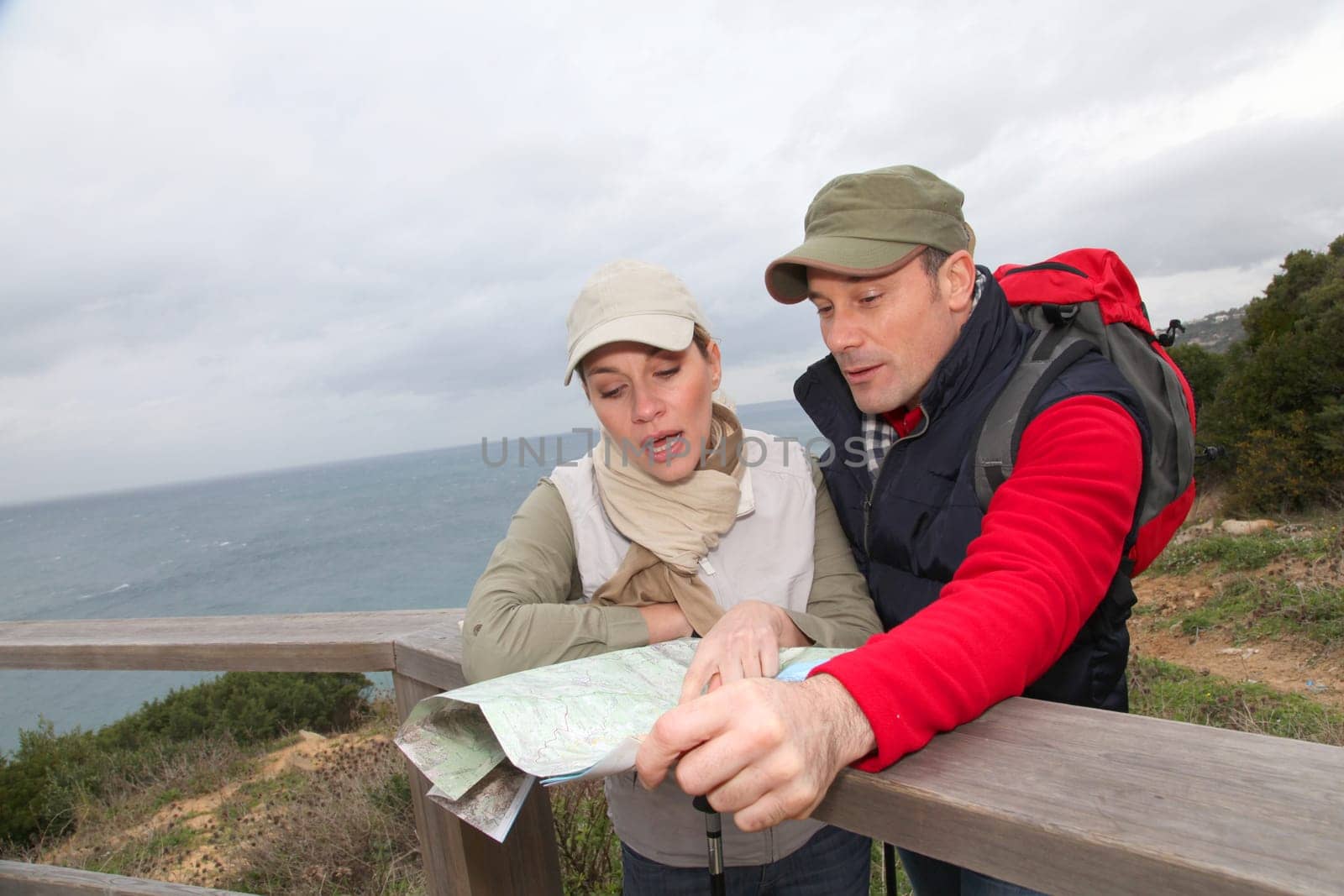 Couple looking at map on a hiking day