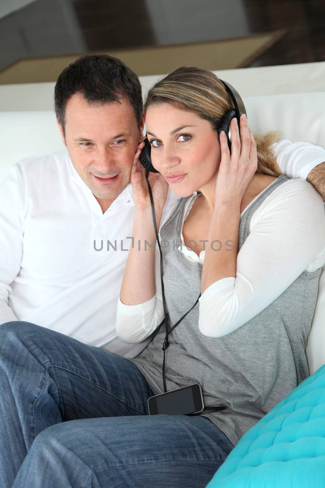 Couple listening to music with headphones