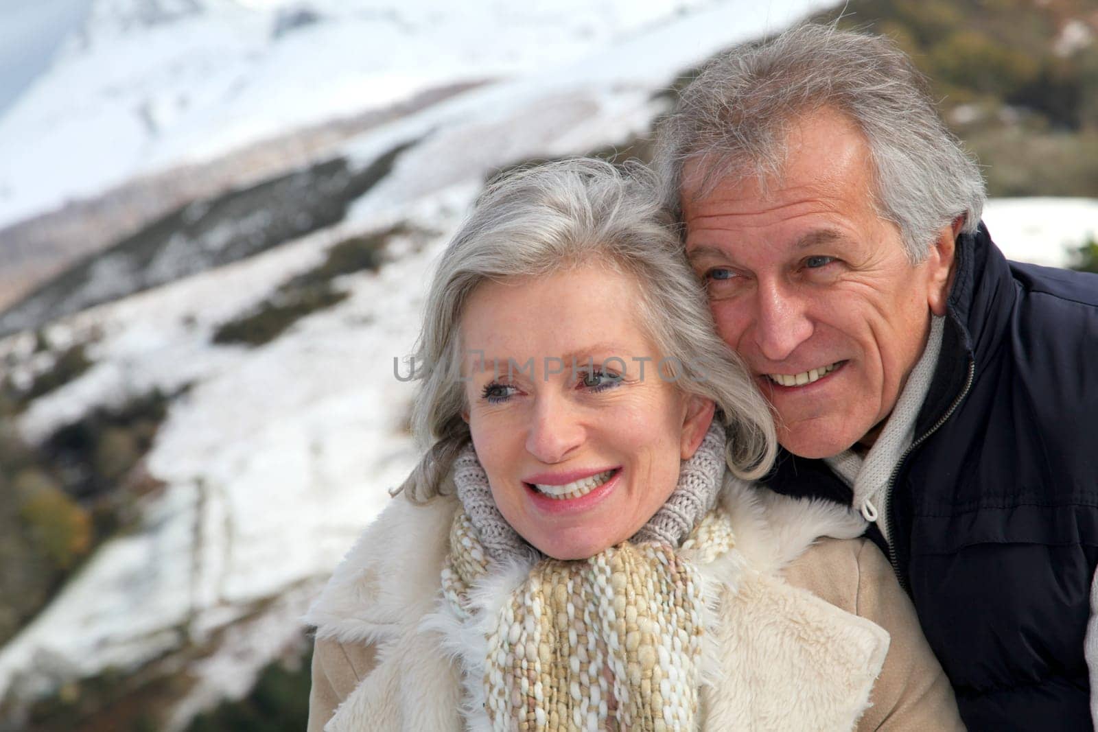 Portrait of happy senior couple at the mountain