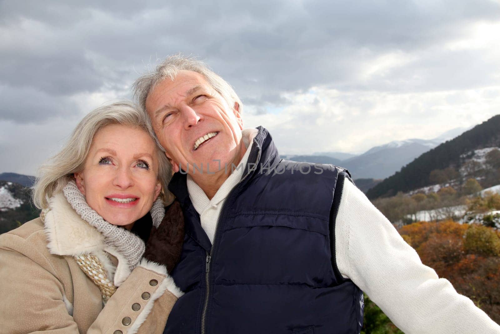 Portrait of happy senior couple at the mountain