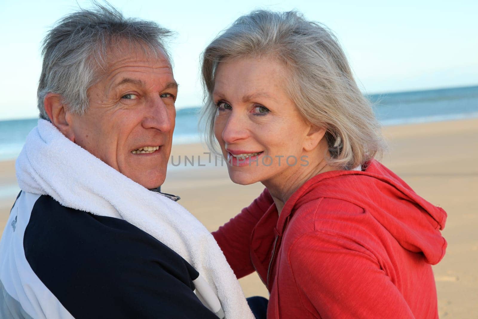 Senior couple exercising by the sea