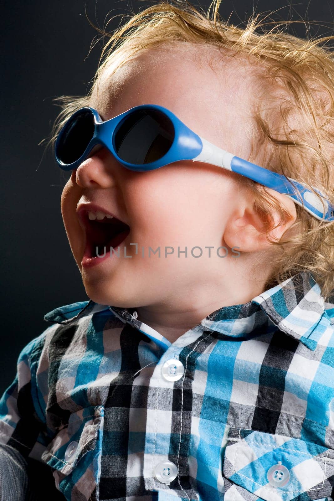 Happy boy with shirt and sunglasses laughing