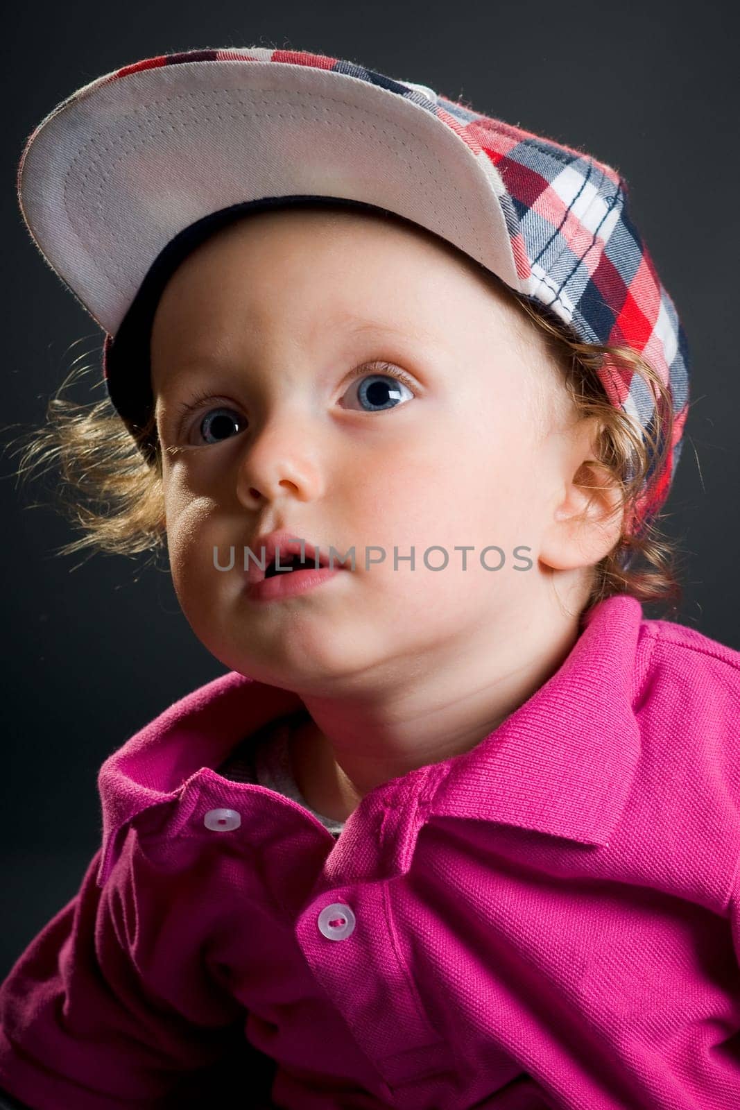 Casual cool young kid with cap against gray background