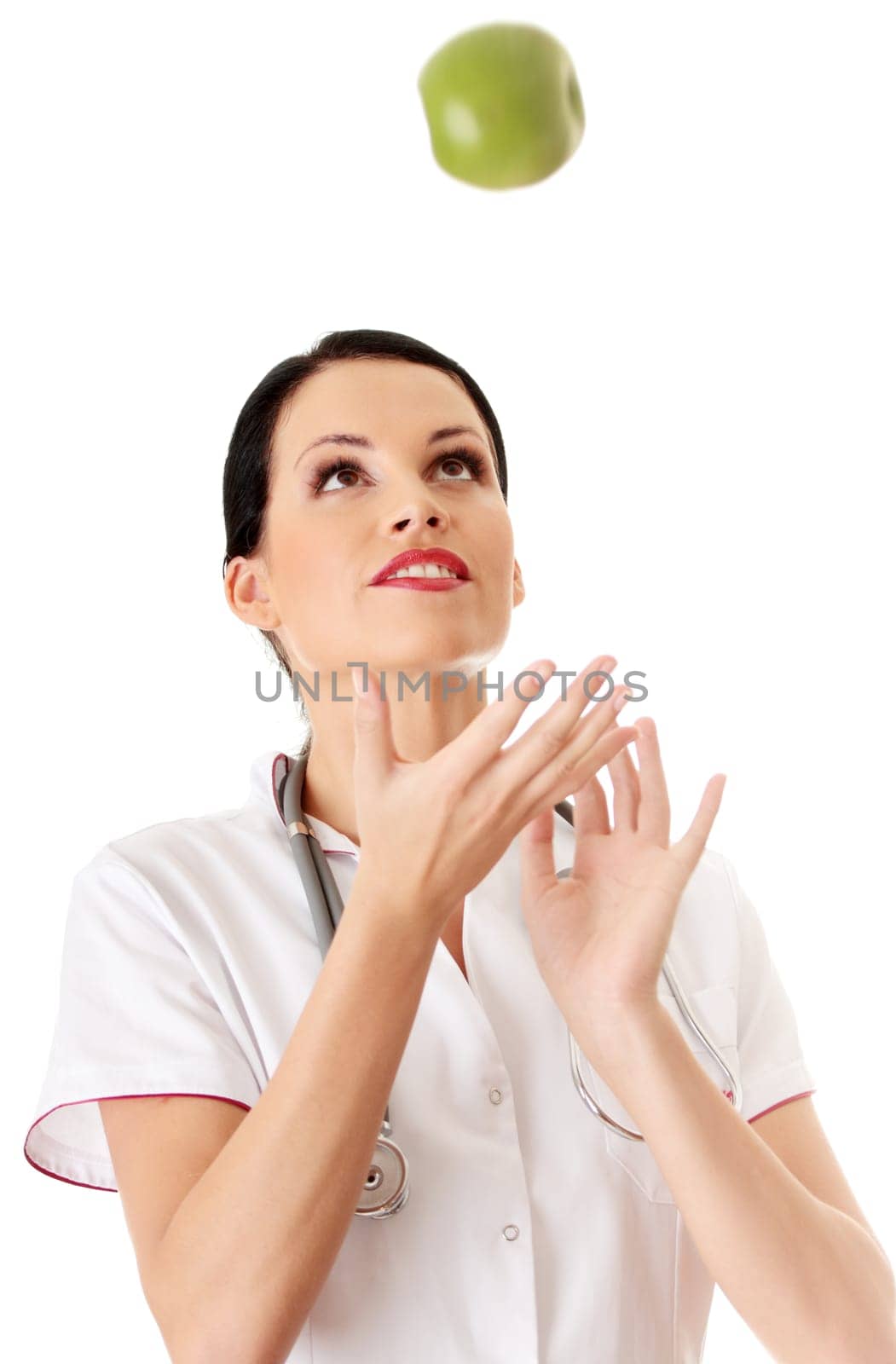 Healthy eating or lifestyle concept. Smiling woman doctor with a green apple.