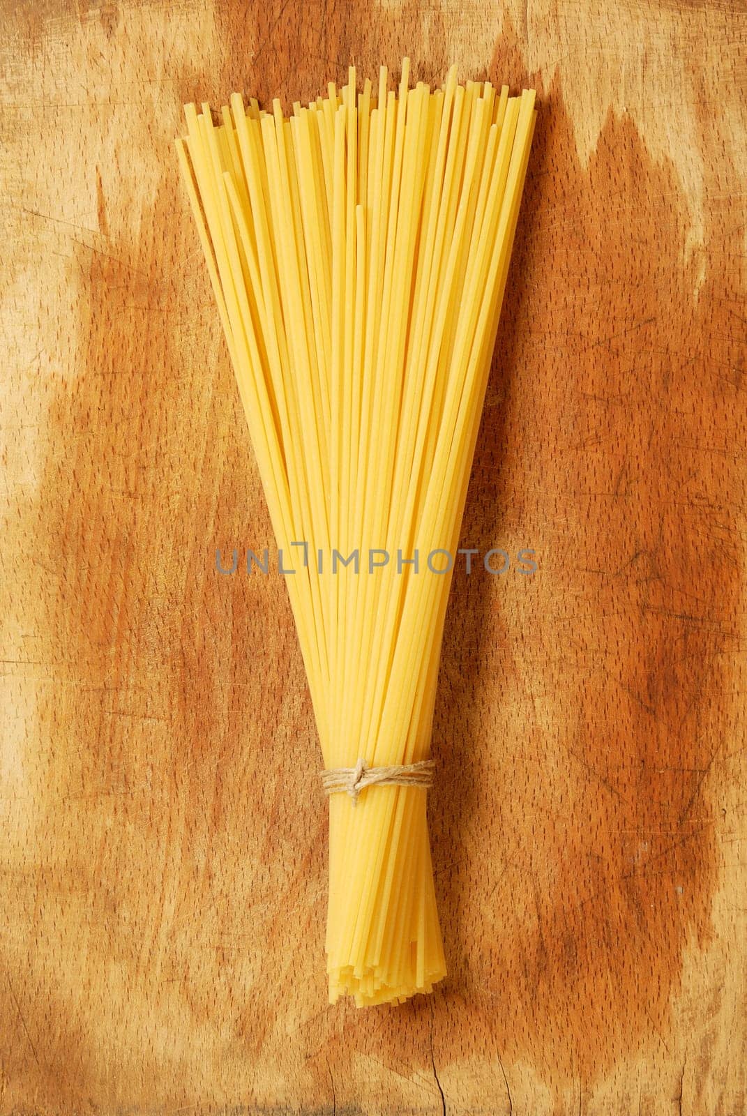 Italian pasta : spaghettis on a wooden background