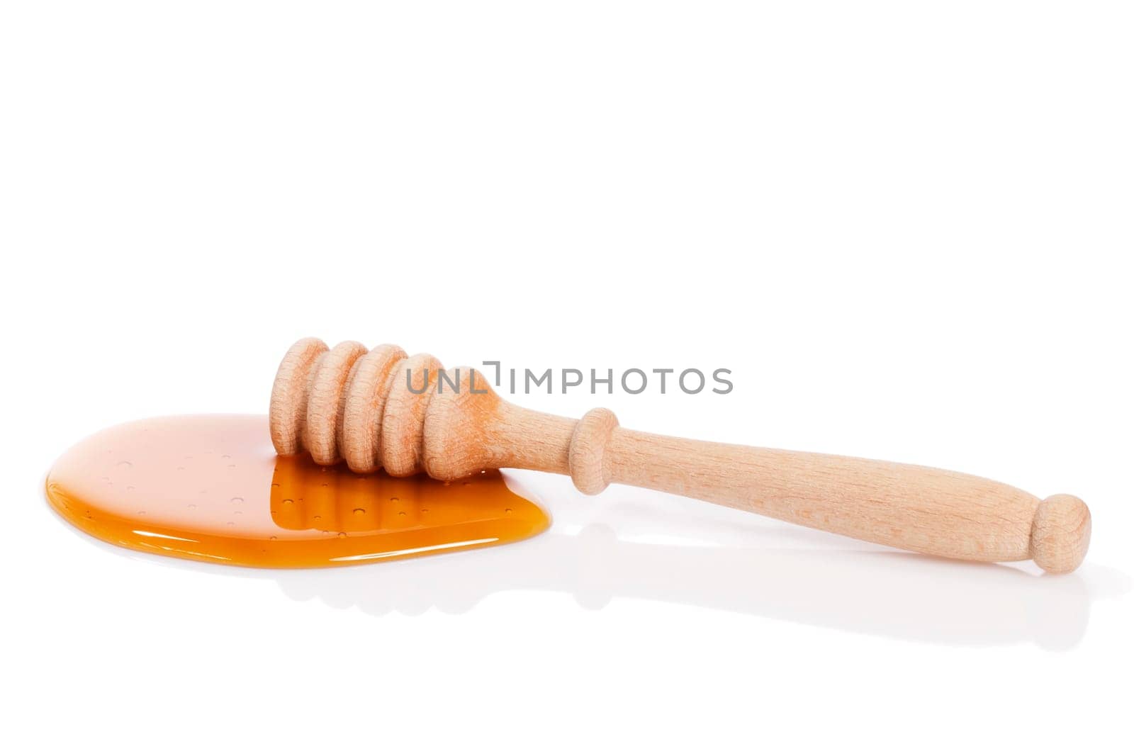 Honey spoon in honey against white background