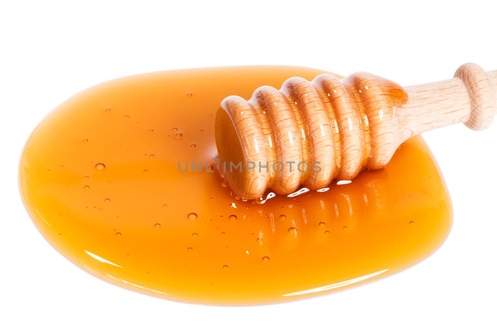 Honey spoon in honey on white background