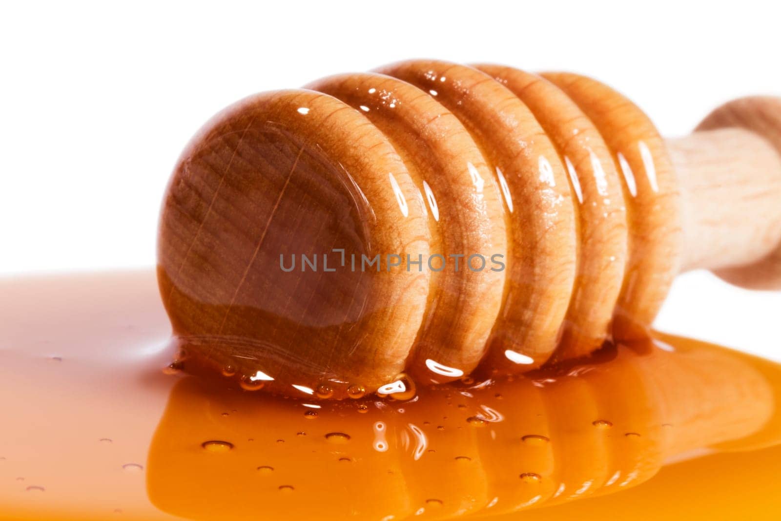 Close-up of a honey spoon in honey