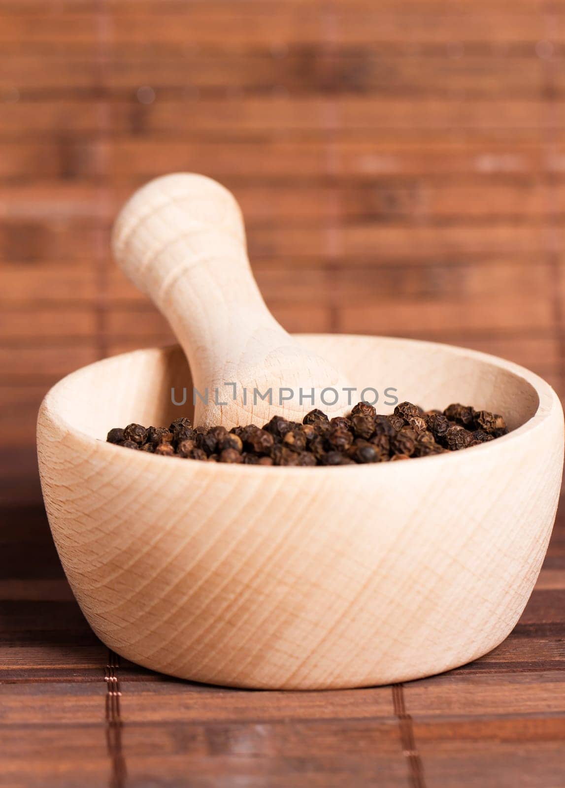 Peppercorns in a wooden mortar