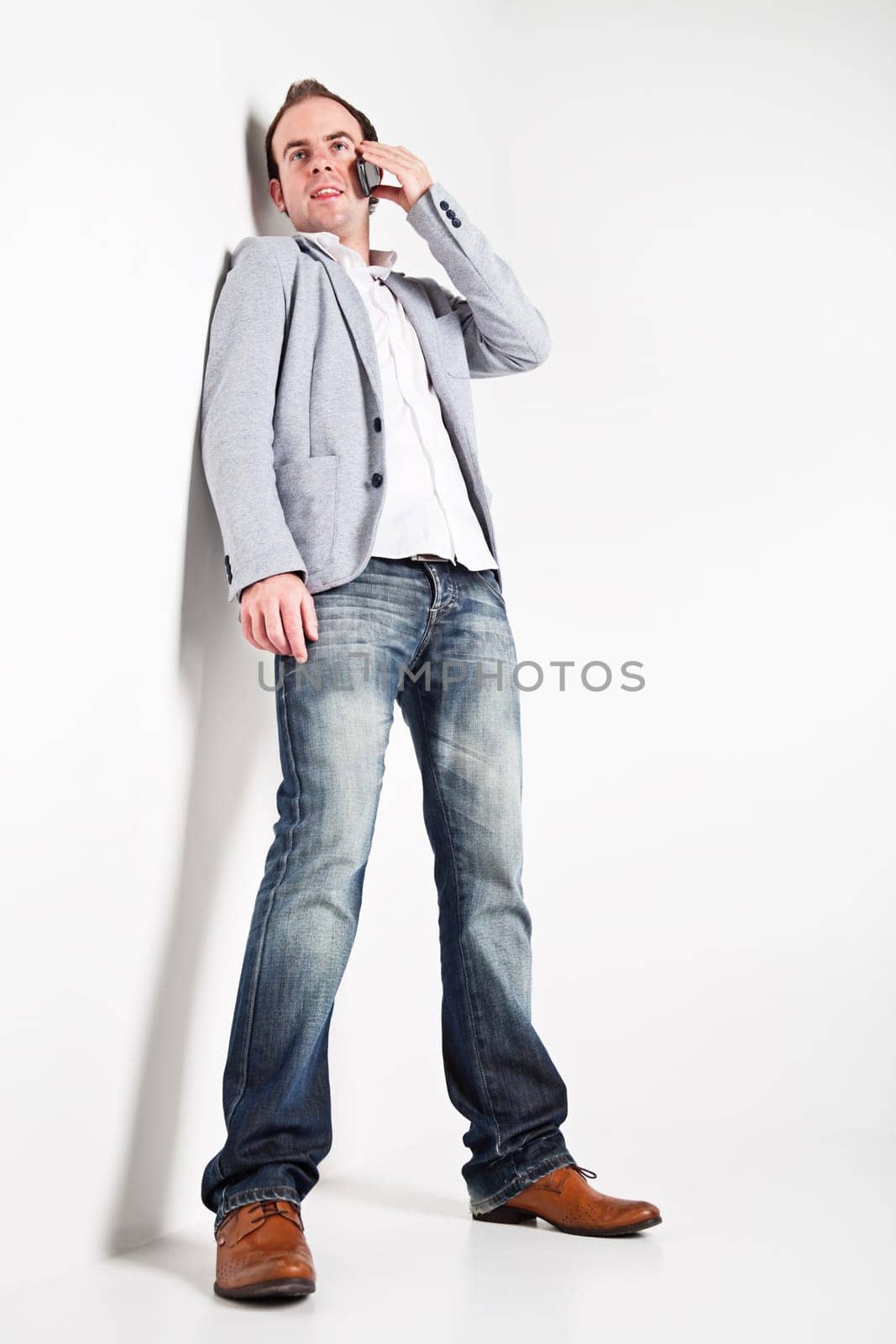 Low angle view at young man speaking on mobile phone