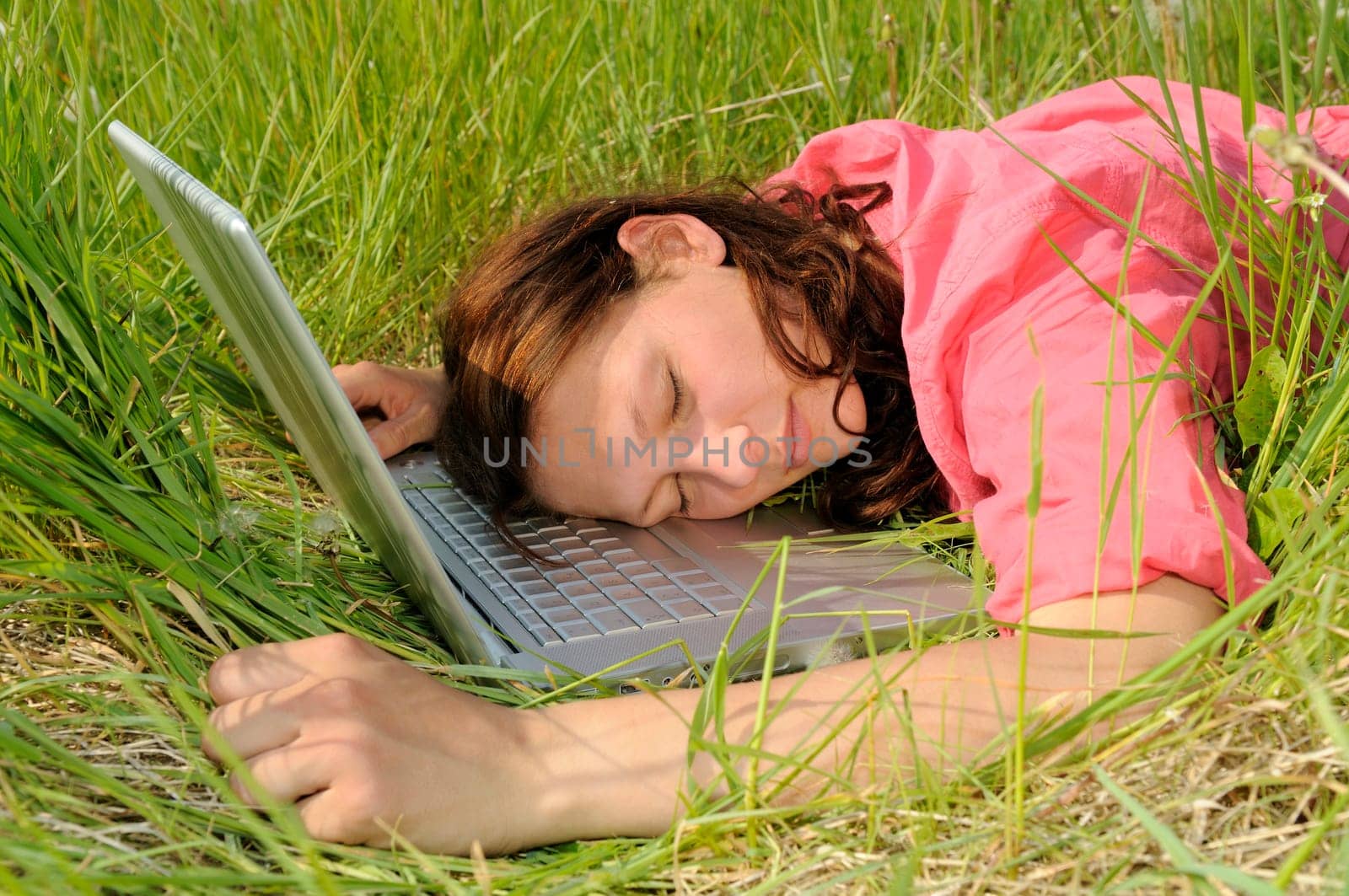 Young woman sleeping on laptop