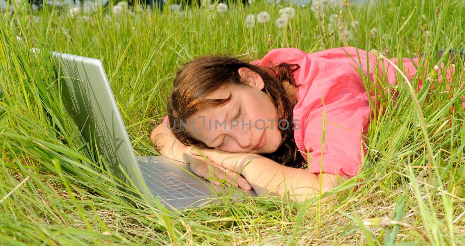 Young woman sleeping on laptop