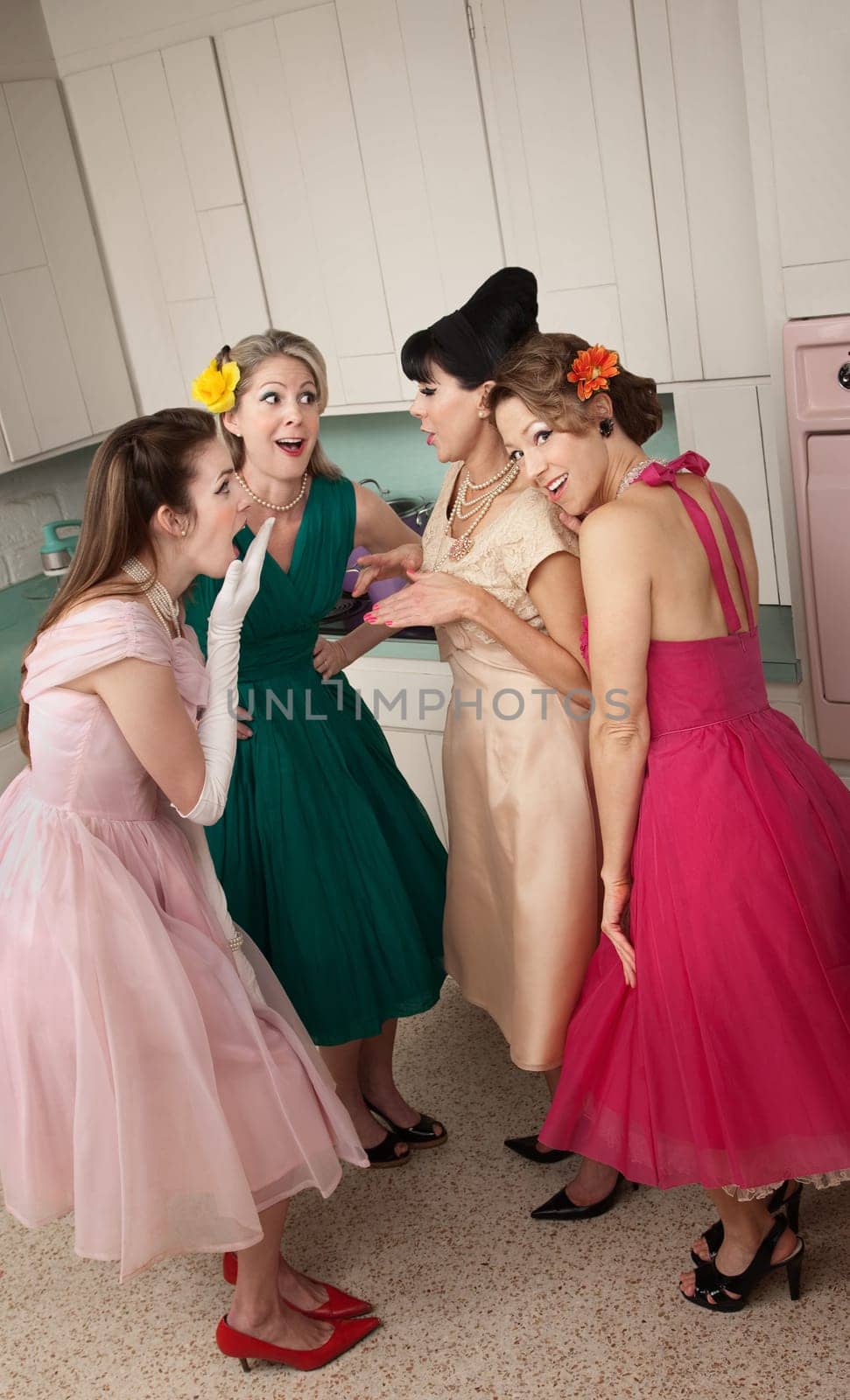 Group of four retro fashion housewives tell secrets in the kitchen