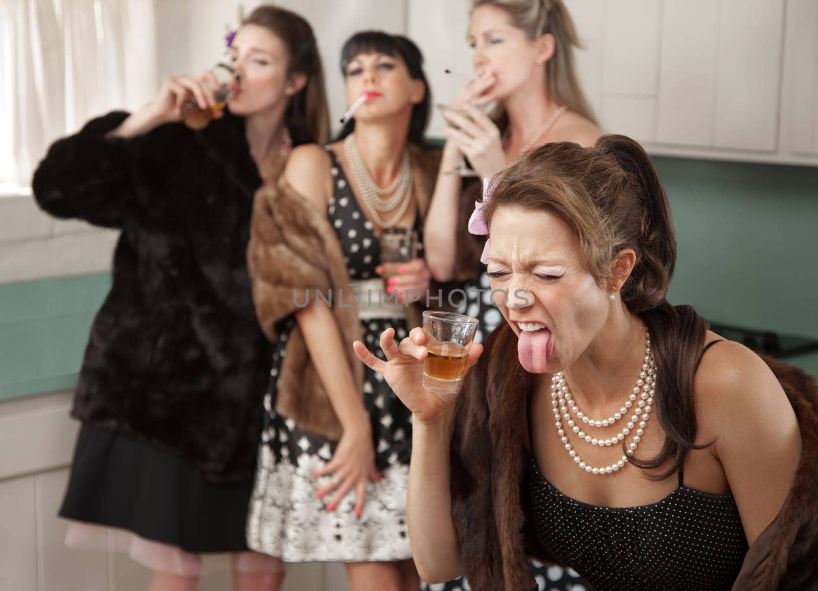 Group of four retro fashion housewives tell secrets in the kitchen