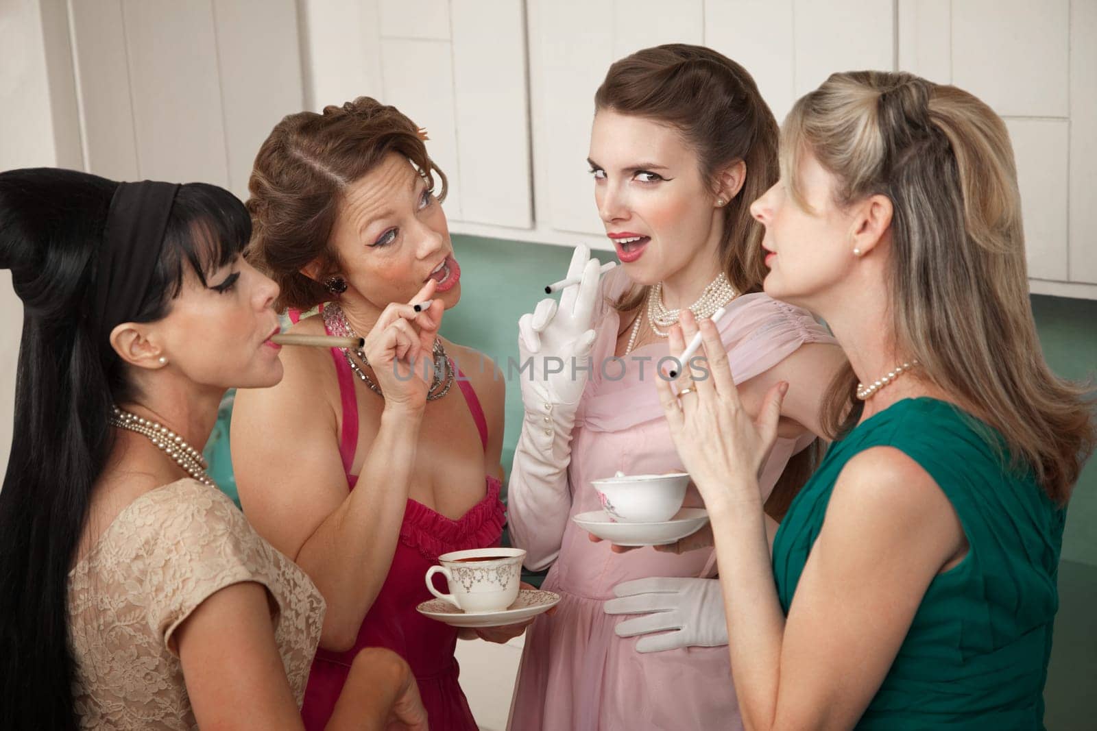 Group of four retro fashion housewives tell secrets in the kitchen