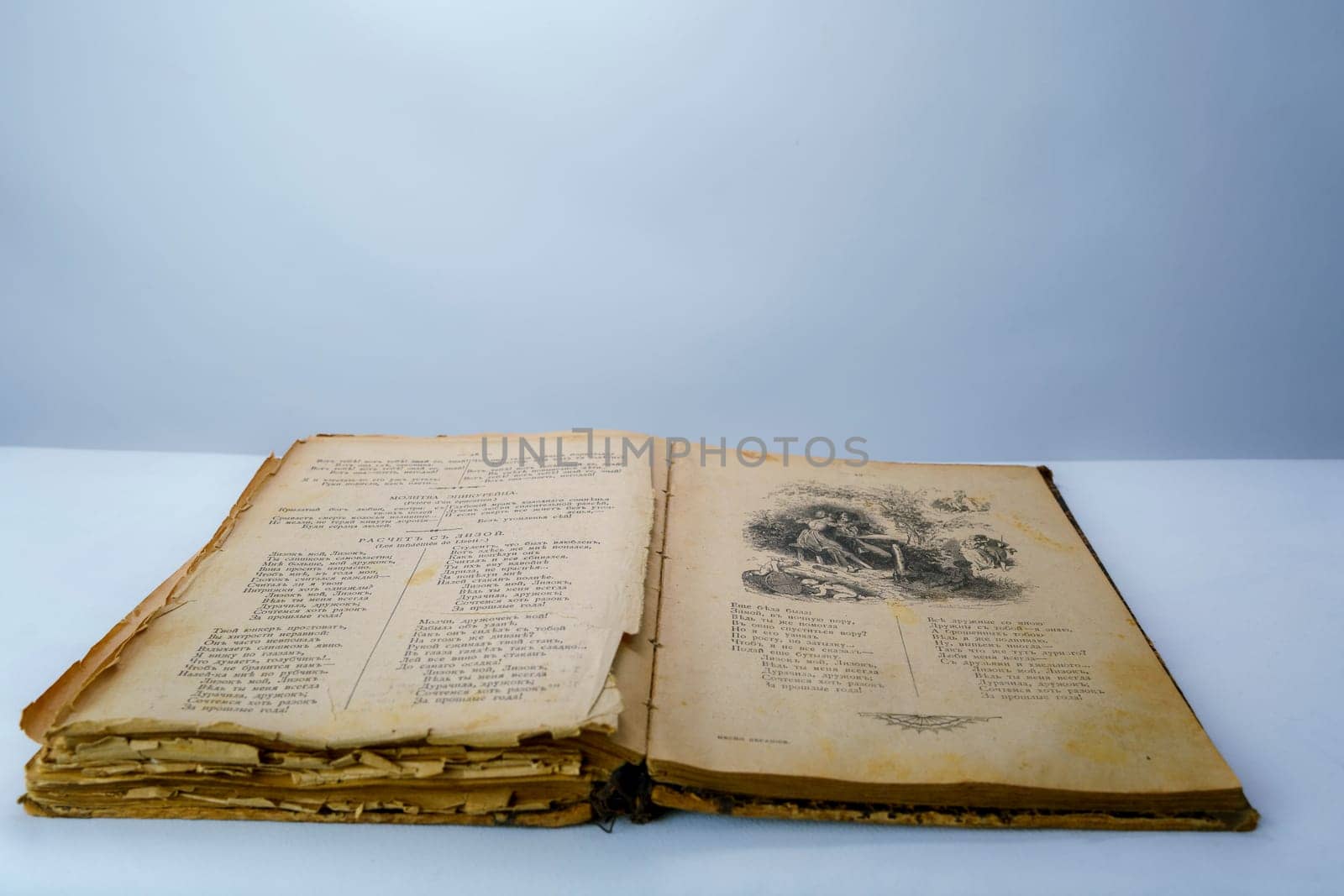 Open old book with fragile, yellowed pages and a vintage black-and-white illustration. Aged historical literature, perfect for themes of knowledge, history, and nostalgia