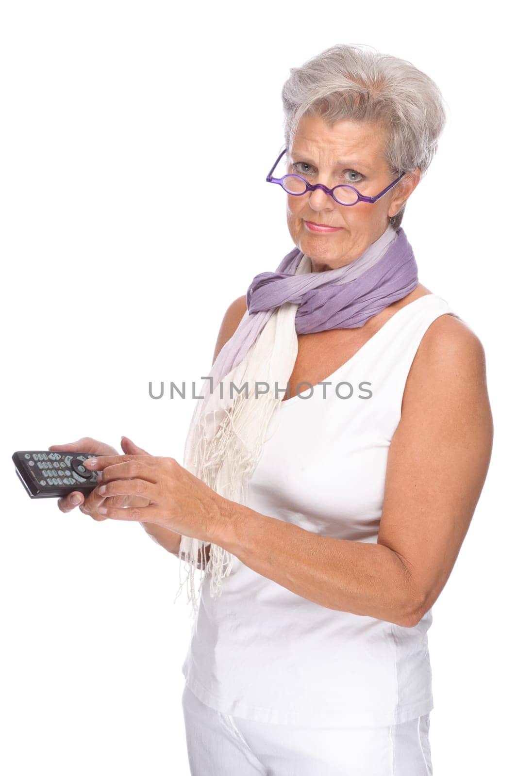 Studio shot of an active senior woman with remote control