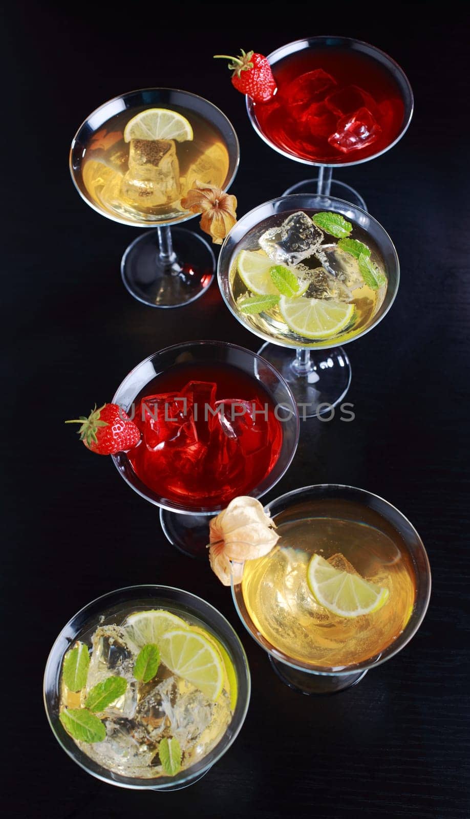 Different cocktails or longdrinks garnished with fruits
