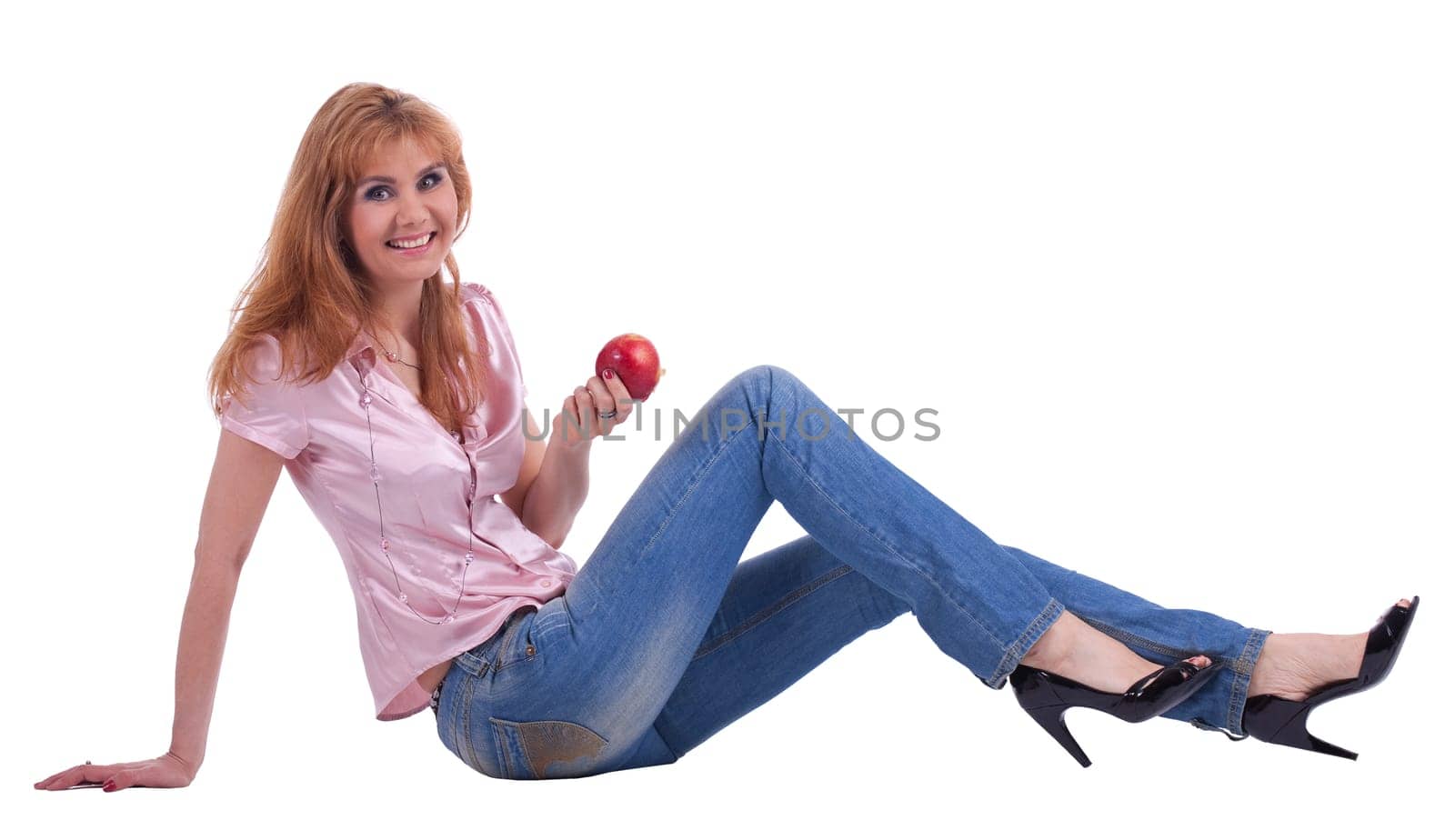 tall Senior woman in jeans sit with apple isolated